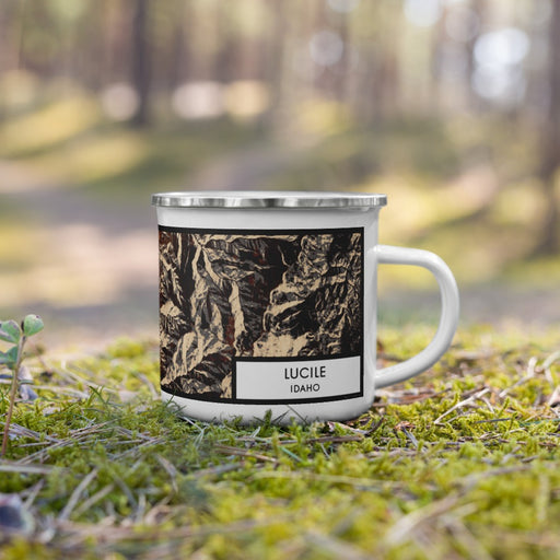 Right View Custom Lucile Idaho Map Enamel Mug in Ember on Grass With Trees in Background
