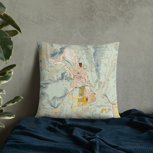Custom Lyons Colorado Map Throw Pillow in Woodblock on Bedding Against Wall