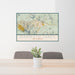 24x36 Mammoth Lakes California Map Print Lanscape Orientation in Woodblock Style Behind 2 Chairs Table and Potted Plant