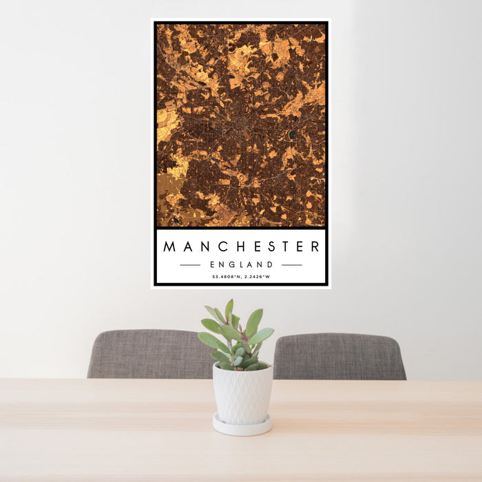 24x36 Manchester England Map Print Portrait Orientation in Ember Style Behind 2 Chairs Table and Potted Plant