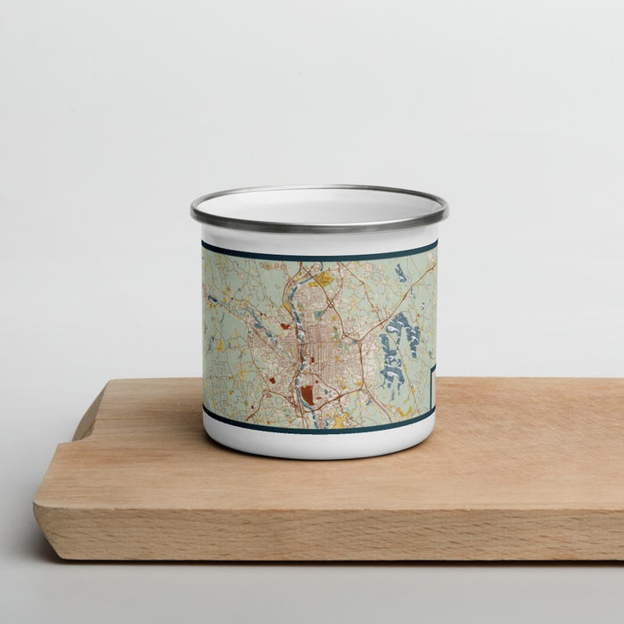 Front View Custom Manchester New Hampshire Map Enamel Mug in Woodblock on Cutting Board