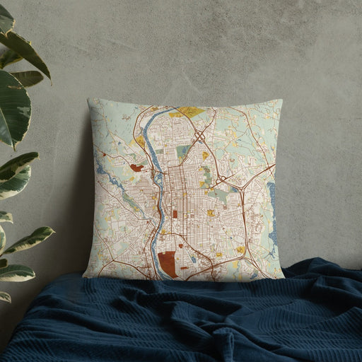 Custom Manchester New Hampshire Map Throw Pillow in Woodblock on Bedding Against Wall