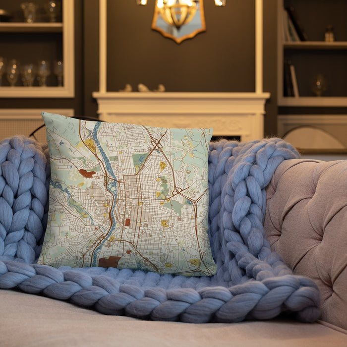 Custom Manchester New Hampshire Map Throw Pillow in Woodblock on Cream Colored Couch