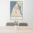 24x36 Manistee Michigan Map Print Portrait Orientation in Woodblock Style Behind 2 Chairs Table and Potted Plant
