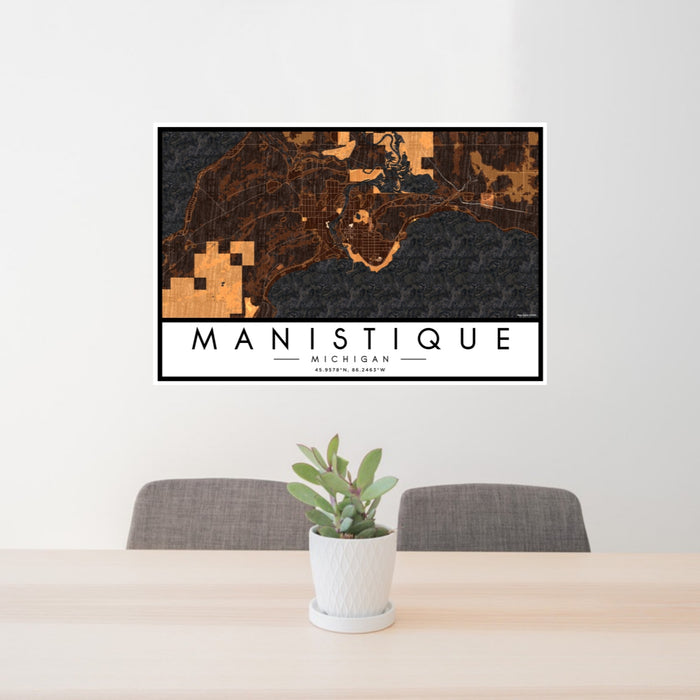 24x36 Manistique Michigan Map Print Lanscape Orientation in Ember Style Behind 2 Chairs Table and Potted Plant