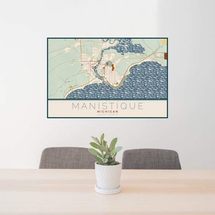 24x36 Manistique Michigan Map Print Lanscape Orientation in Woodblock Style Behind 2 Chairs Table and Potted Plant