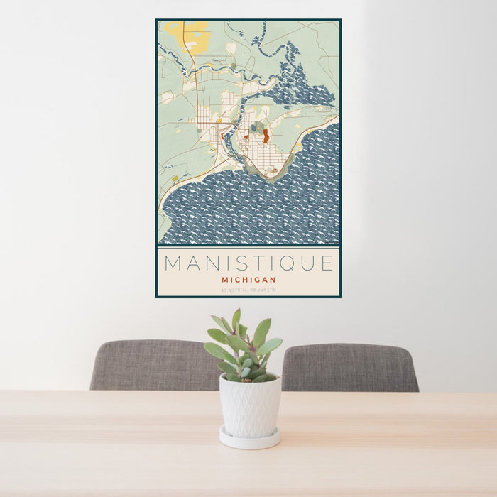 24x36 Manistique Michigan Map Print Portrait Orientation in Woodblock Style Behind 2 Chairs Table and Potted Plant