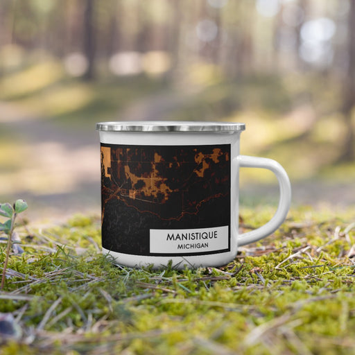 Right View Custom Manistique Michigan Map Enamel Mug in Ember on Grass With Trees in Background