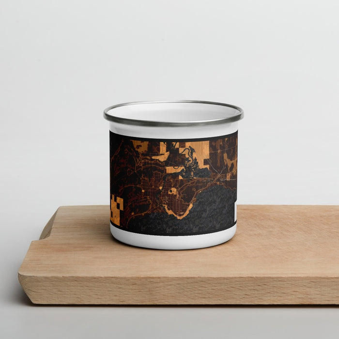 Front View Custom Manistique Michigan Map Enamel Mug in Ember on Cutting Board