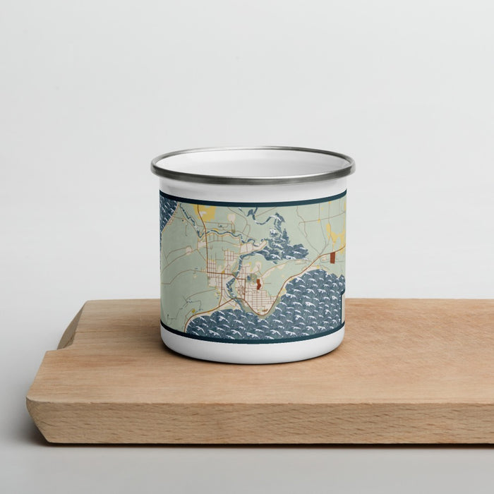 Front View Custom Manistique Michigan Map Enamel Mug in Woodblock on Cutting Board