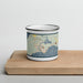 Front View Custom Manistique Michigan Map Enamel Mug in Woodblock on Cutting Board