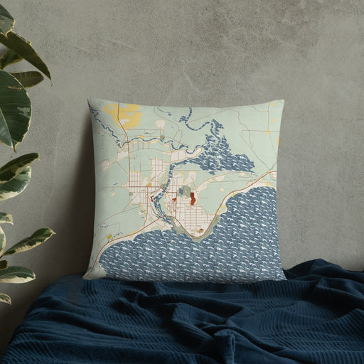 Custom Manistique Michigan Map Throw Pillow in Woodblock on Bedding Against Wall