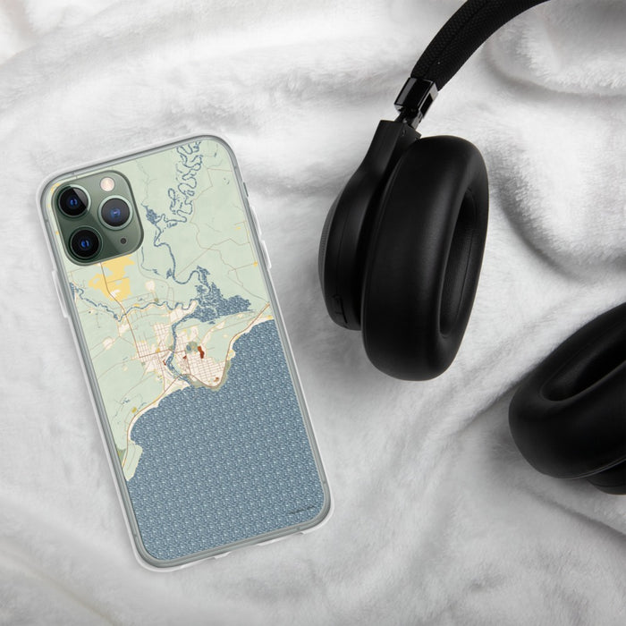 Custom Manistique Michigan Map Phone Case in Woodblock on Table with Black Headphones