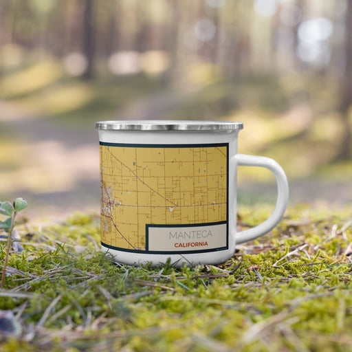 Right View Custom Manteca California Map Enamel Mug in Woodblock on Grass With Trees in Background