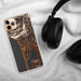 Custom Manzanita Oregon Map Phone Case in Ember on Table with Black Headphones