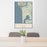 24x36 Manzanita Oregon Map Print Portrait Orientation in Woodblock Style Behind 2 Chairs Table and Potted Plant