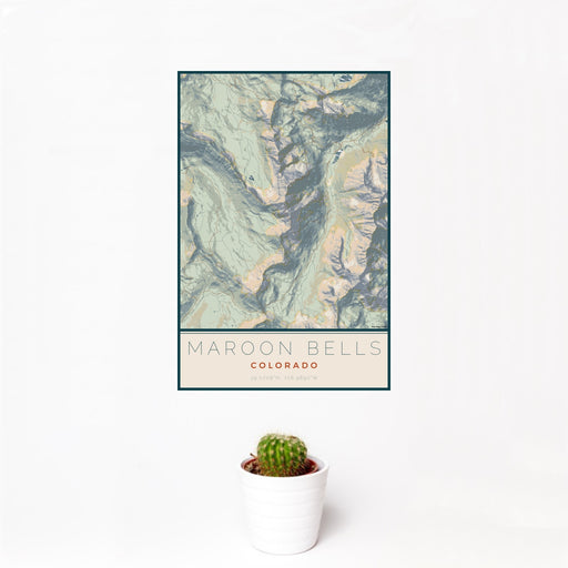 12x18 Maroon Bells Colorado Map Print Portrait Orientation in Woodblock Style With Small Cactus Plant in White Planter