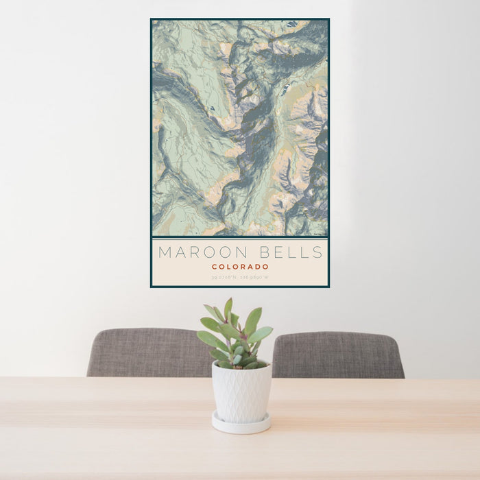 24x36 Maroon Bells Colorado Map Print Portrait Orientation in Woodblock Style Behind 2 Chairs Table and Potted Plant