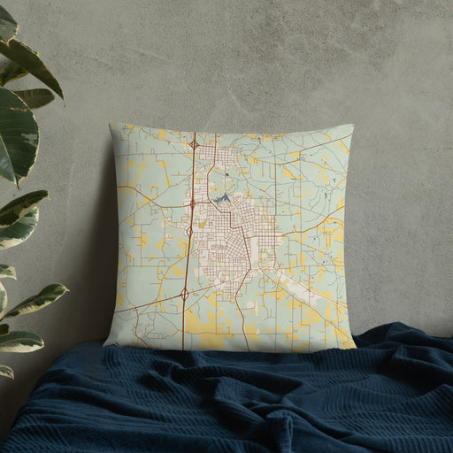 Custom McComb Mississippi Map Throw Pillow in Woodblock on Bedding Against Wall