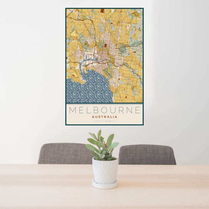 24x36 Melbourne Australia Map Print Portrait Orientation in Woodblock Style Behind 2 Chairs Table and Potted Plant