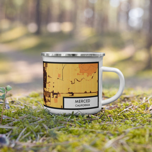Right View Custom Merced California Map Enamel Mug in Ember on Grass With Trees in Background