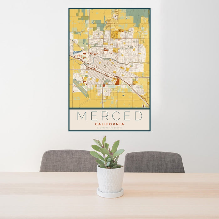 24x36 Merced California Map Print Portrait Orientation in Woodblock Style Behind 2 Chairs Table and Potted Plant