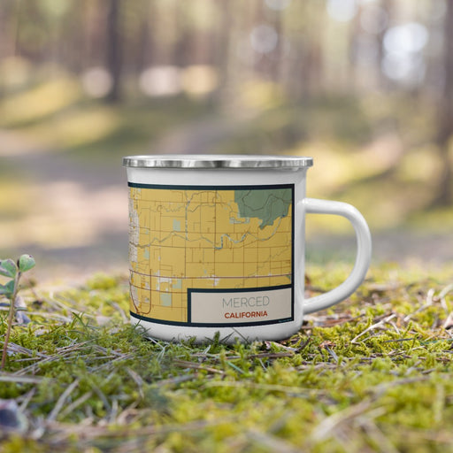 Right View Custom Merced California Map Enamel Mug in Woodblock on Grass With Trees in Background