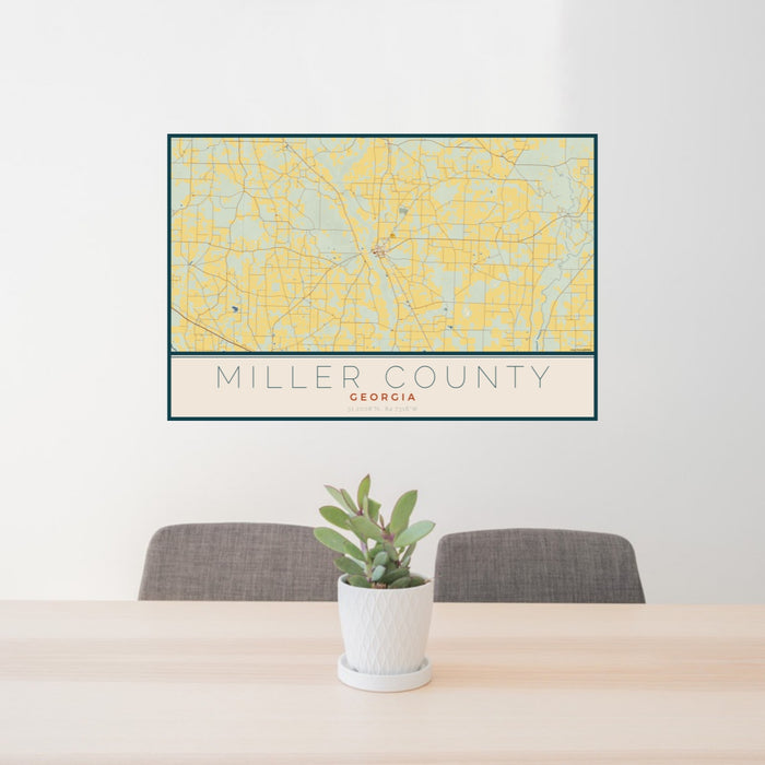 24x36 Miller County Georgia Map Print Landscape Orientation in Woodblock Style Behind 2 Chairs Table and Potted Plant