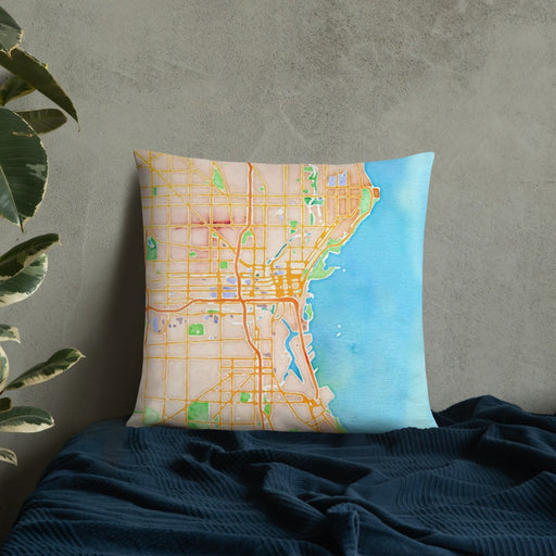 Custom Milwaukee Wisconsin Map Throw Pillow in Watercolor on Bedding Against Wall