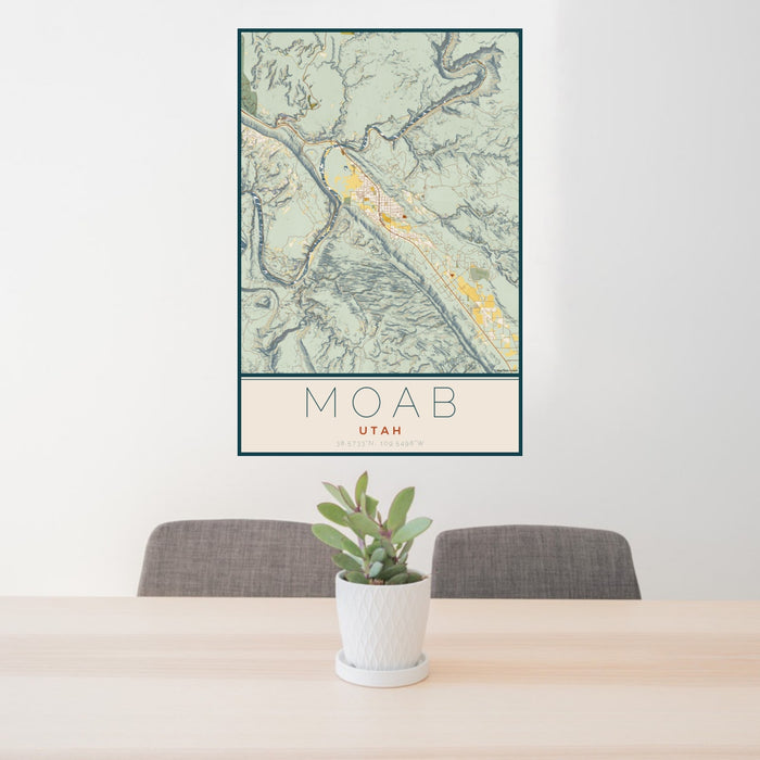 24x36 Moab Utah Map Print Portrait Orientation in Woodblock Style Behind 2 Chairs Table and Potted Plant