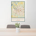 24x36 Montgomery Alabama Map Print Portrait Orientation in Woodblock Style Behind 2 Chairs Table and Potted Plant