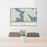 24x36 Mooselookmeguntic Maine Map Print Lanscape Orientation in Woodblock Style Behind 2 Chairs Table and Potted Plant