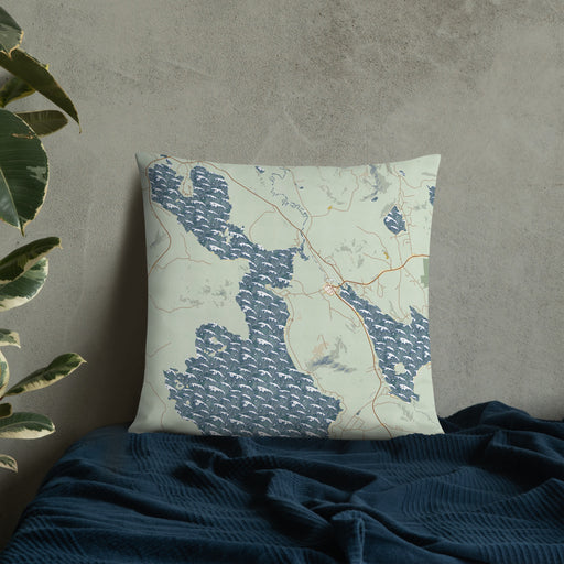 Custom Mooselookmeguntic Maine Map Throw Pillow in Woodblock on Bedding Against Wall