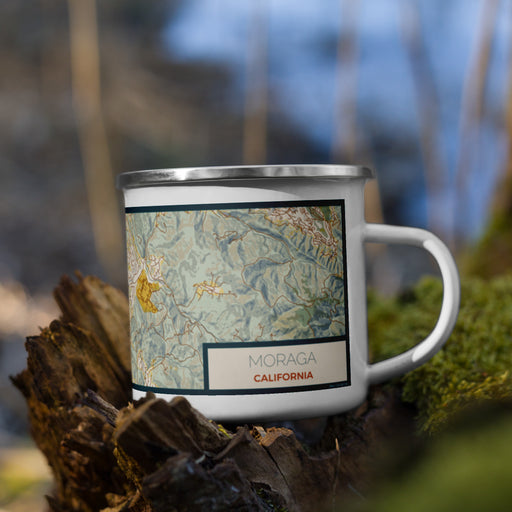 Right View Custom Moraga California Map Enamel Mug in Woodblock on Grass With Trees in Background