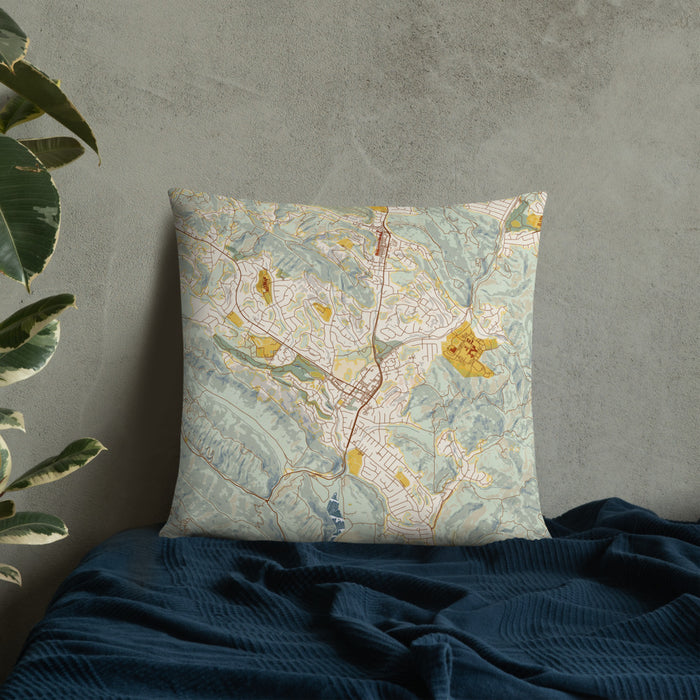 Custom Moraga California Map Throw Pillow in Woodblock on Bedding Against Wall