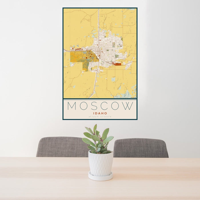 24x36 Moscow Idaho Map Print Portrait Orientation in Woodblock Style Behind 2 Chairs Table and Potted Plant