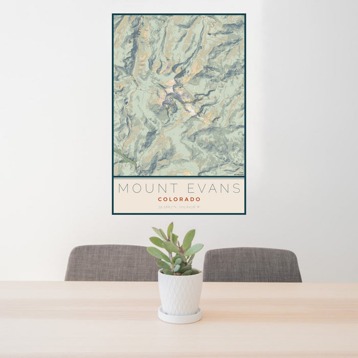 24x36 Mount Evans Colorado Map Print Portrait Orientation in Woodblock Style Behind 2 Chairs Table and Potted Plant