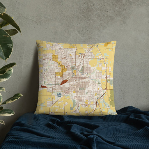 Custom Muncie Indiana Map Throw Pillow in Woodblock on Bedding Against Wall
