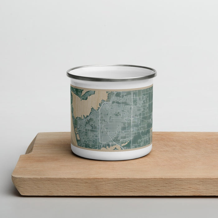 Front View Custom Muskegon Michigan Map Enamel Mug in Afternoon on Cutting Board