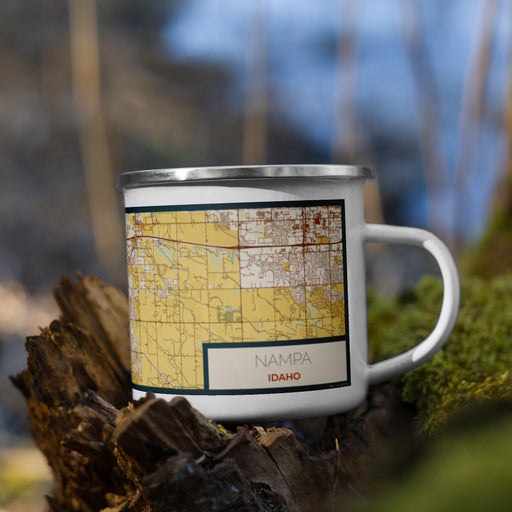 Right View Custom Nampa Idaho Map Enamel Mug in Woodblock on Grass With Trees in Background