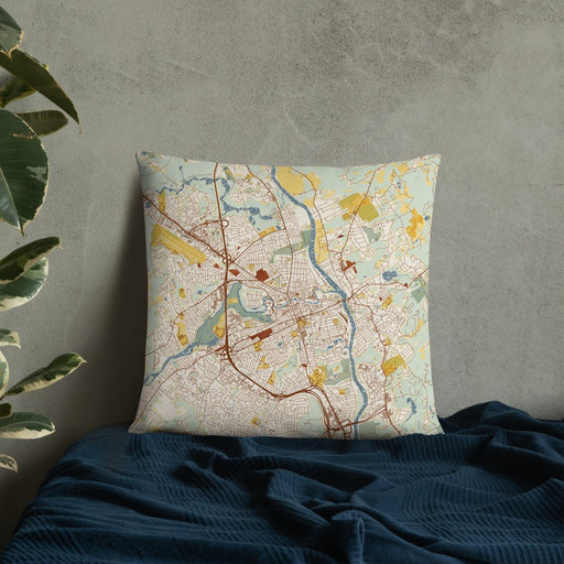 Custom Nashua New Hampshire Map Throw Pillow in Woodblock on Bedding Against Wall