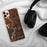 Custom Naugatuck Connecticut Map Phone Case in Ember on Table with Black Headphones