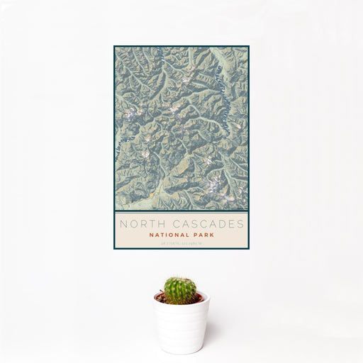 12x18 North Cascades National Park Map Print Portrait Orientation in Woodblock Style With Small Cactus Plant in White Planter