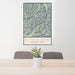 24x36 North Cascades National Park Map Print Portrait Orientation in Woodblock Style Behind 2 Chairs Table and Potted Plant