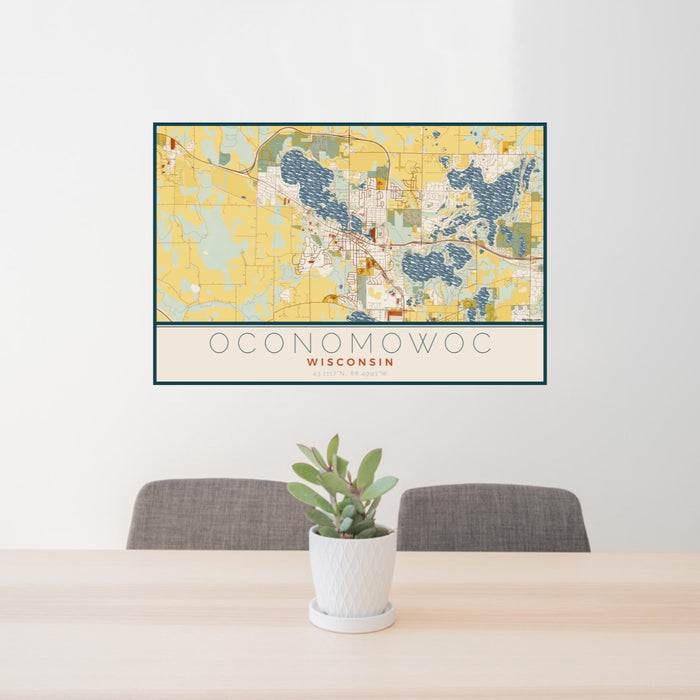 24x36 Oconomowoc Wisconsin Map Print Lanscape Orientation in Woodblock Style Behind 2 Chairs Table and Potted Plant