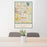24x36 Okemos Michigan Map Print Portrait Orientation in Woodblock Style Behind 2 Chairs Table and Potted Plant