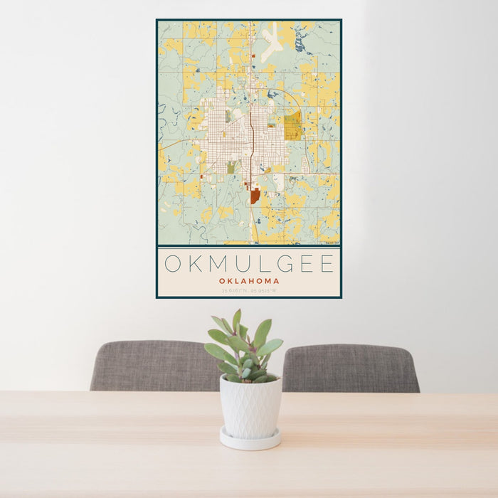 24x36 Okmulgee Oklahoma Map Print Portrait Orientation in Woodblock Style Behind 2 Chairs Table and Potted Plant