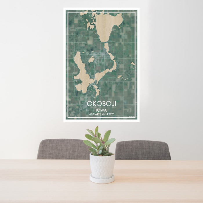 24x36 Okoboji Iowa Map Print Portrait Orientation in Afternoon Style Behind 2 Chairs Table and Potted Plant