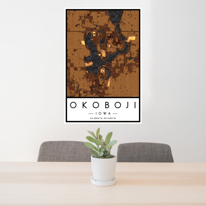 24x36 Okoboji Iowa Map Print Portrait Orientation in Ember Style Behind 2 Chairs Table and Potted Plant