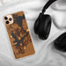 Custom Okoboji Iowa Map Phone Case in Ember on Table with Black Headphones